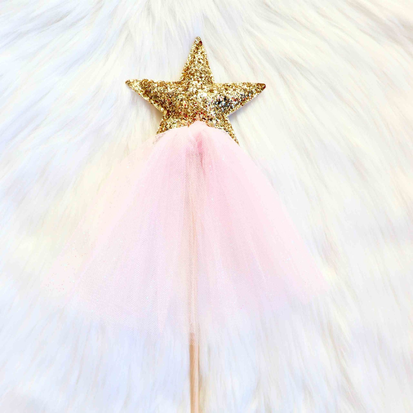 a pink tutu skirt with a gold star on top