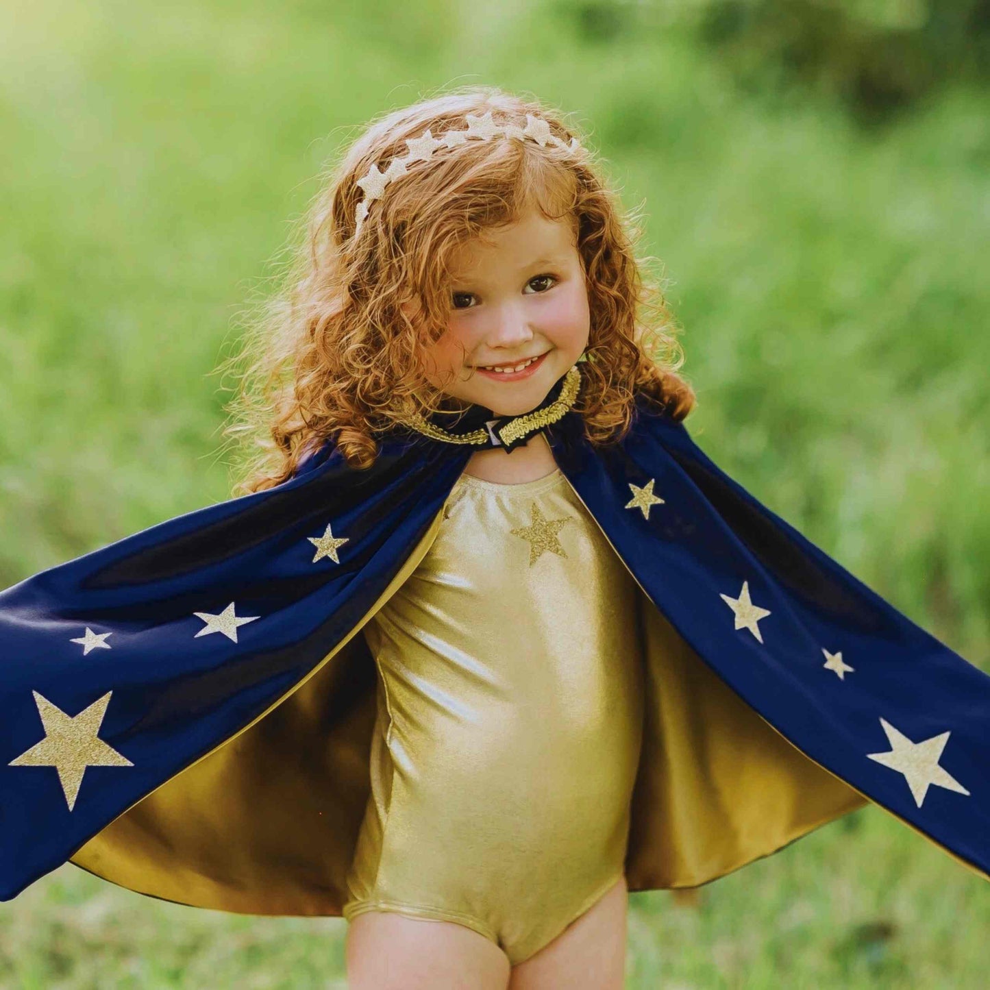 a little girl dressed up like a superhero