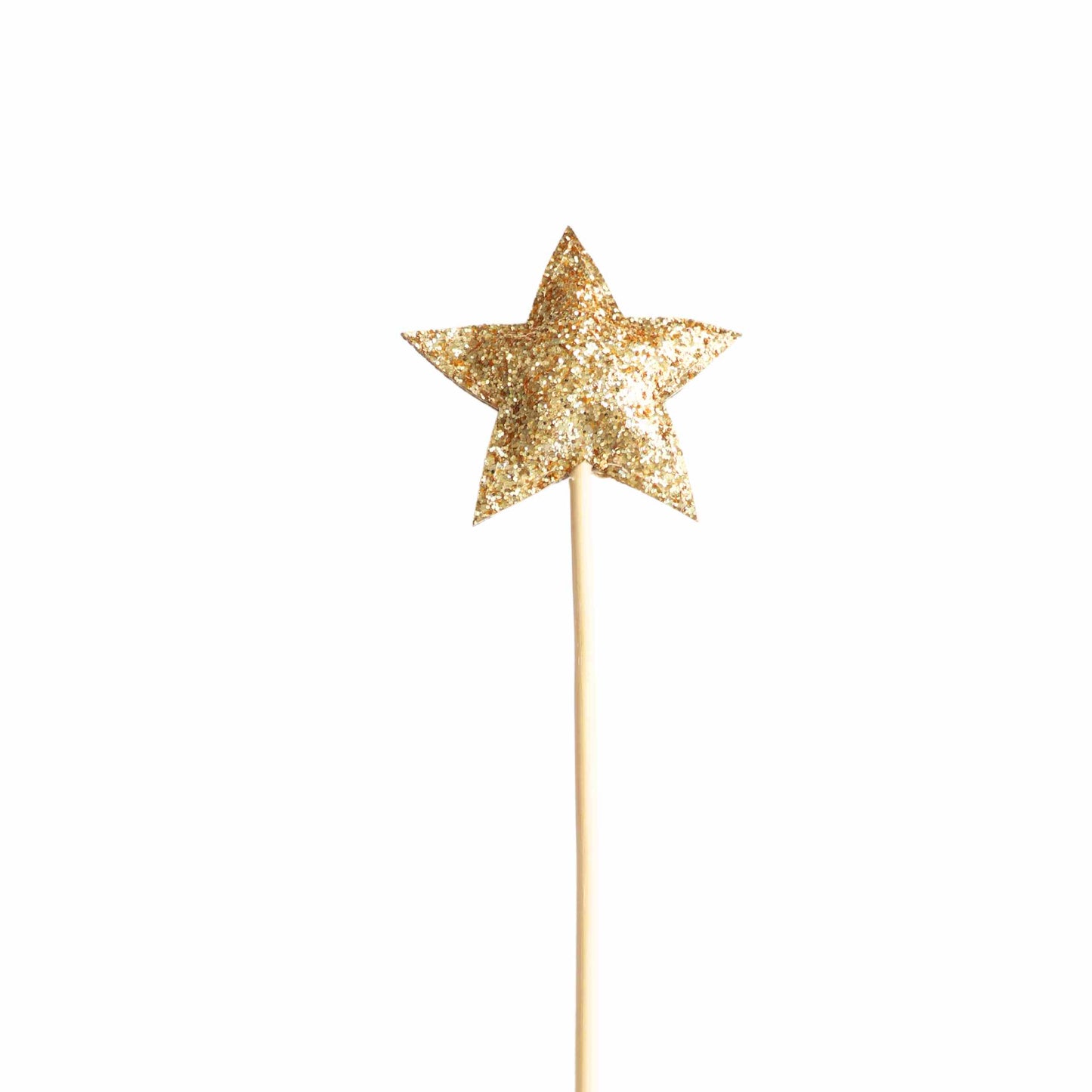 a gold star shaped cake topper on a stick