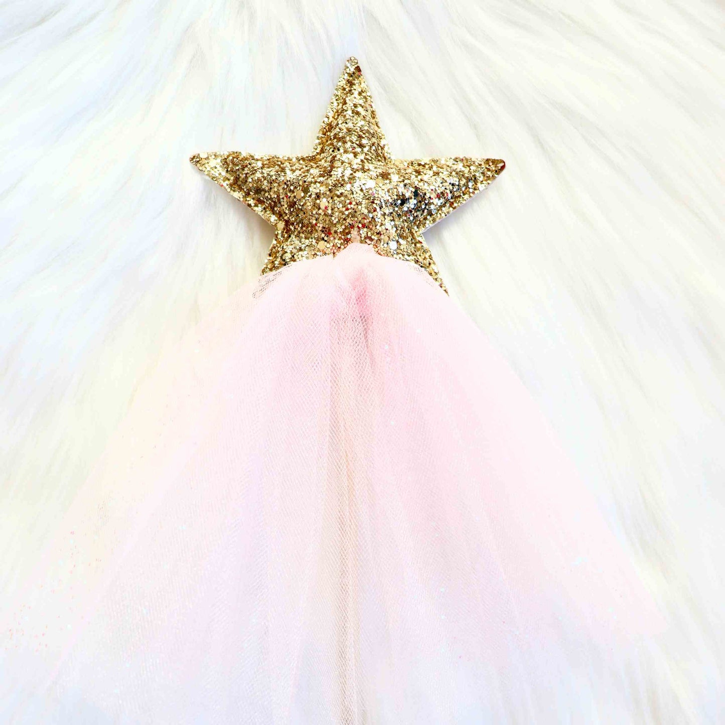 a gold star on a pink tulle skirt
