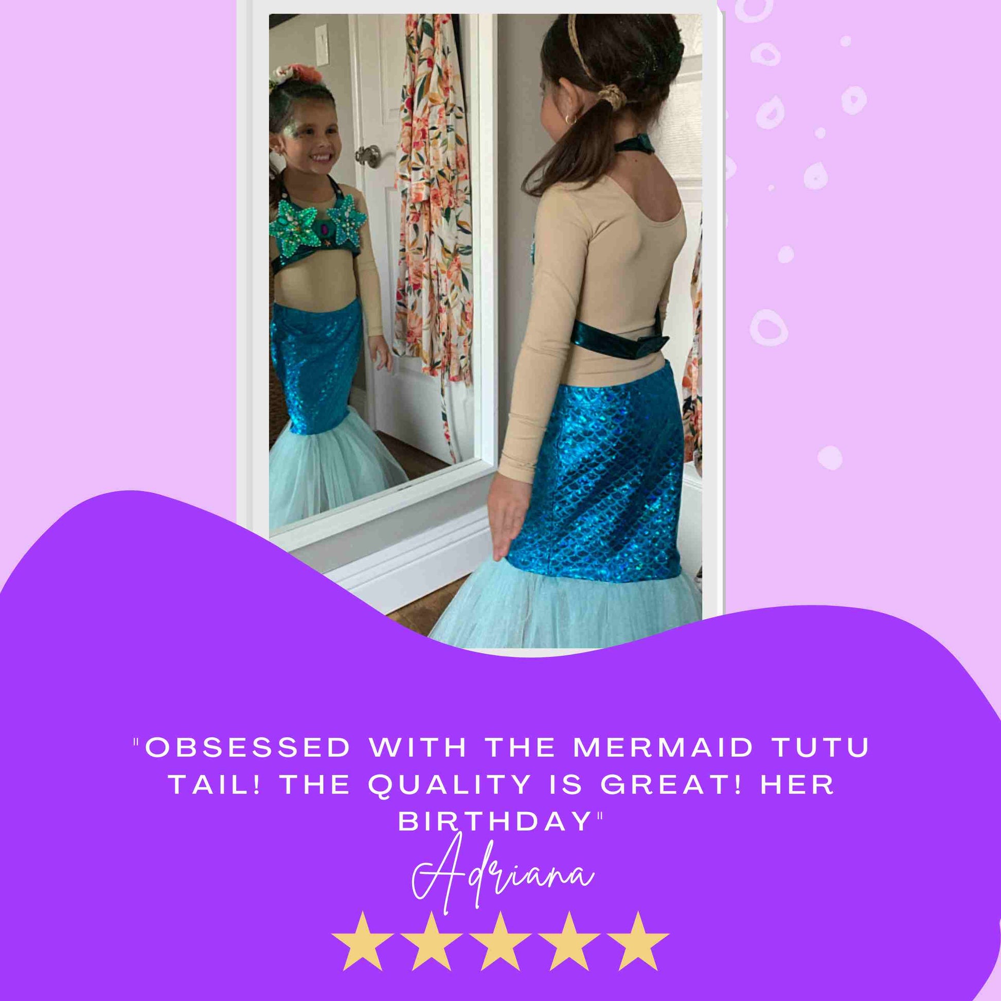 a little girl in a mermaid costume looking in a mirror