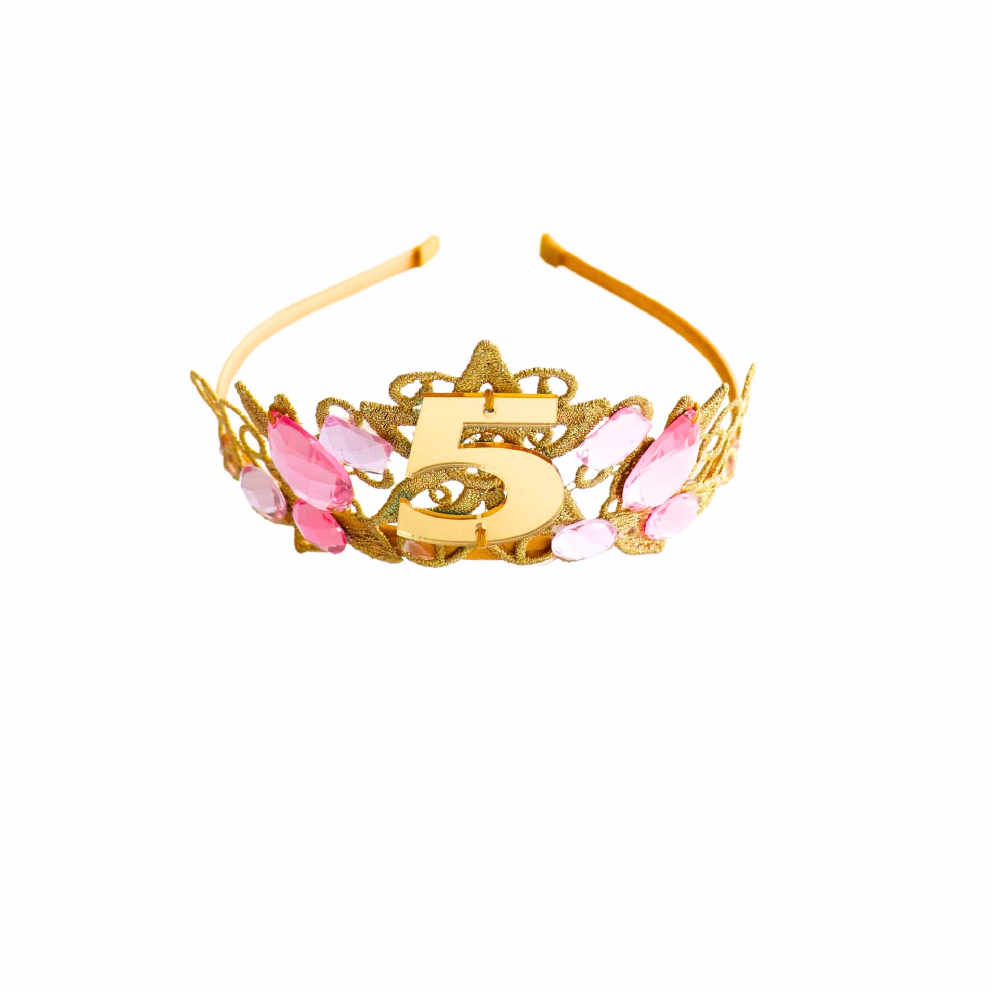 a gold and pink tiara with the letter g on it