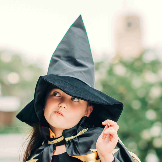 a little girl dressed up as a wizard