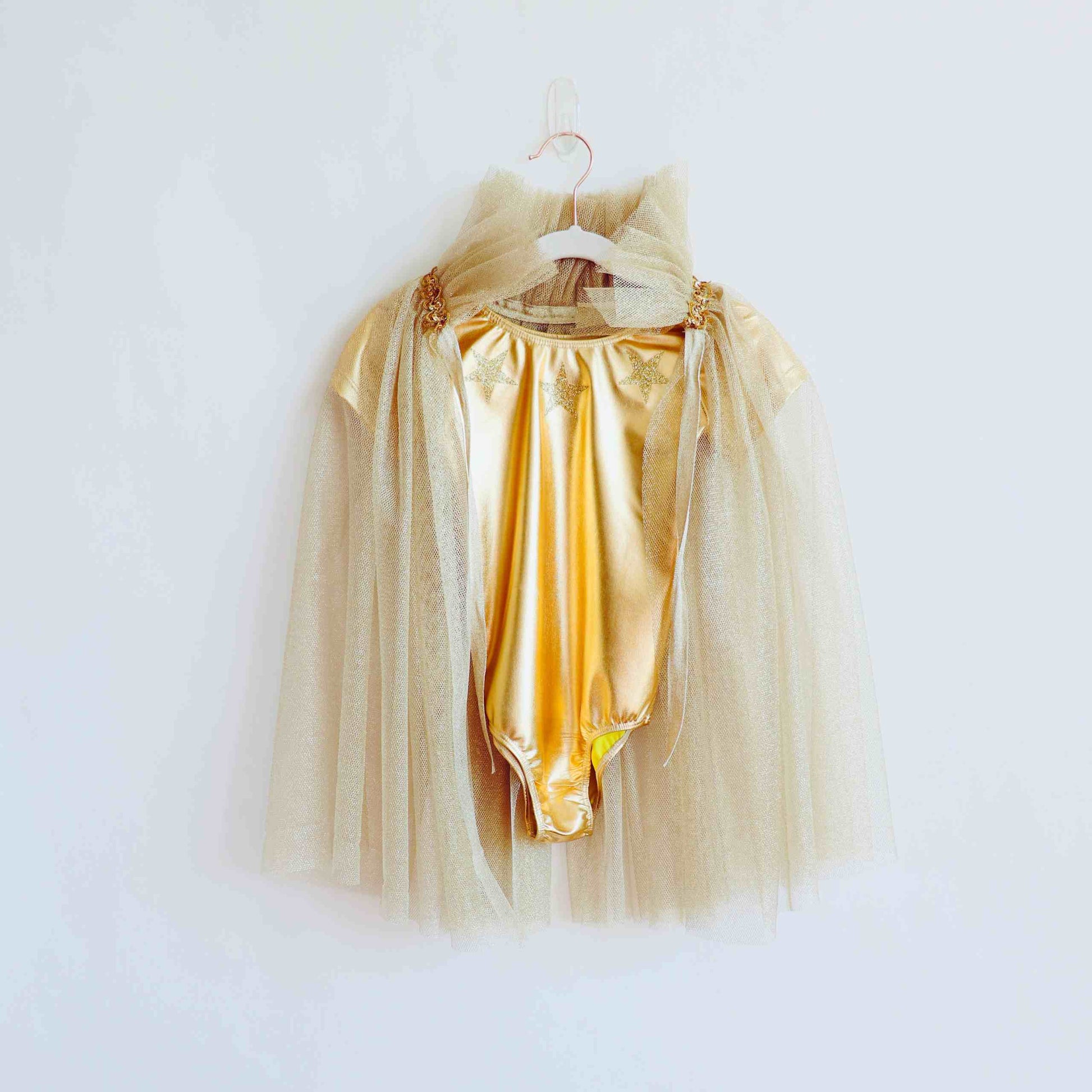 a dress hanging on a hanger on a wall