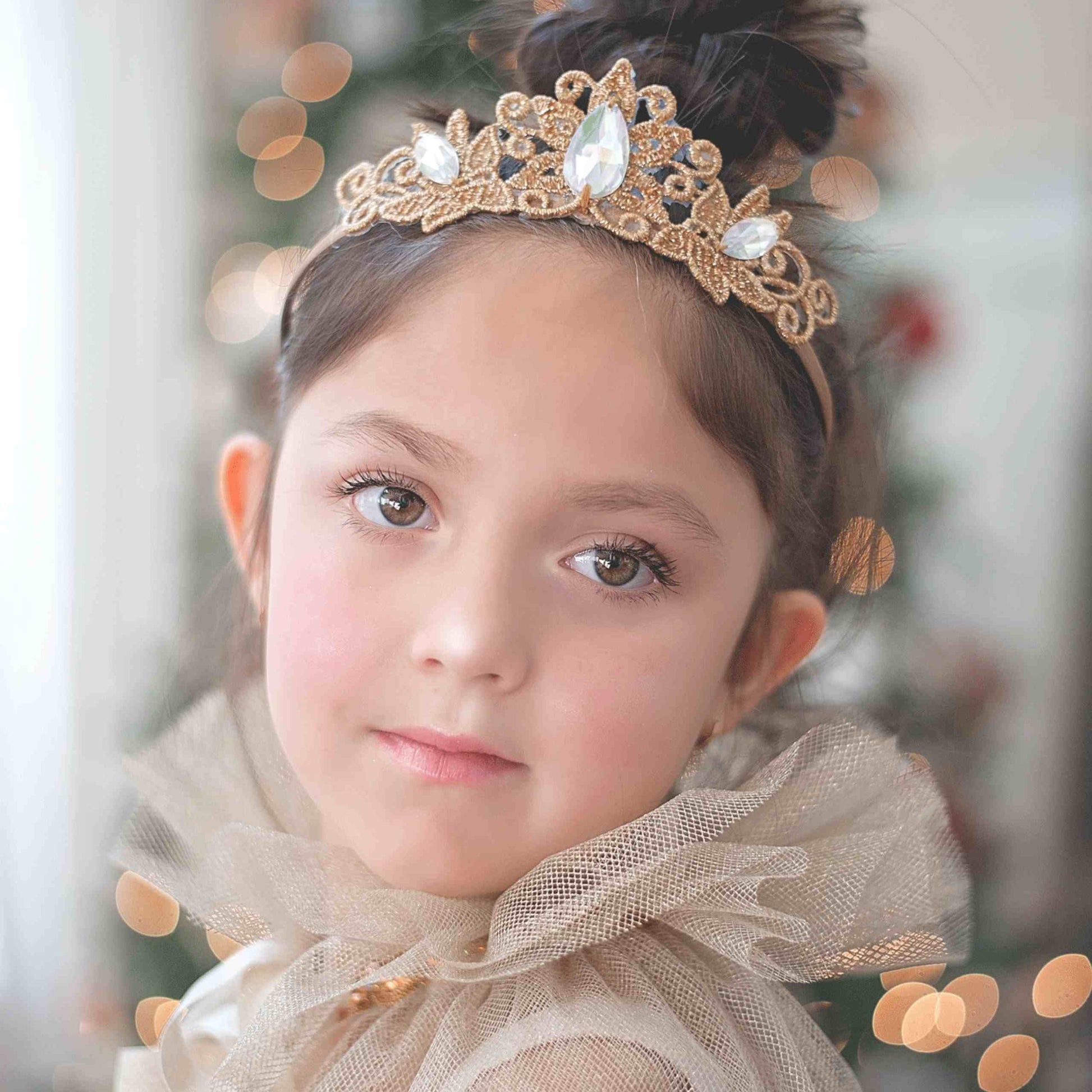 a little girl with a tiara on her head