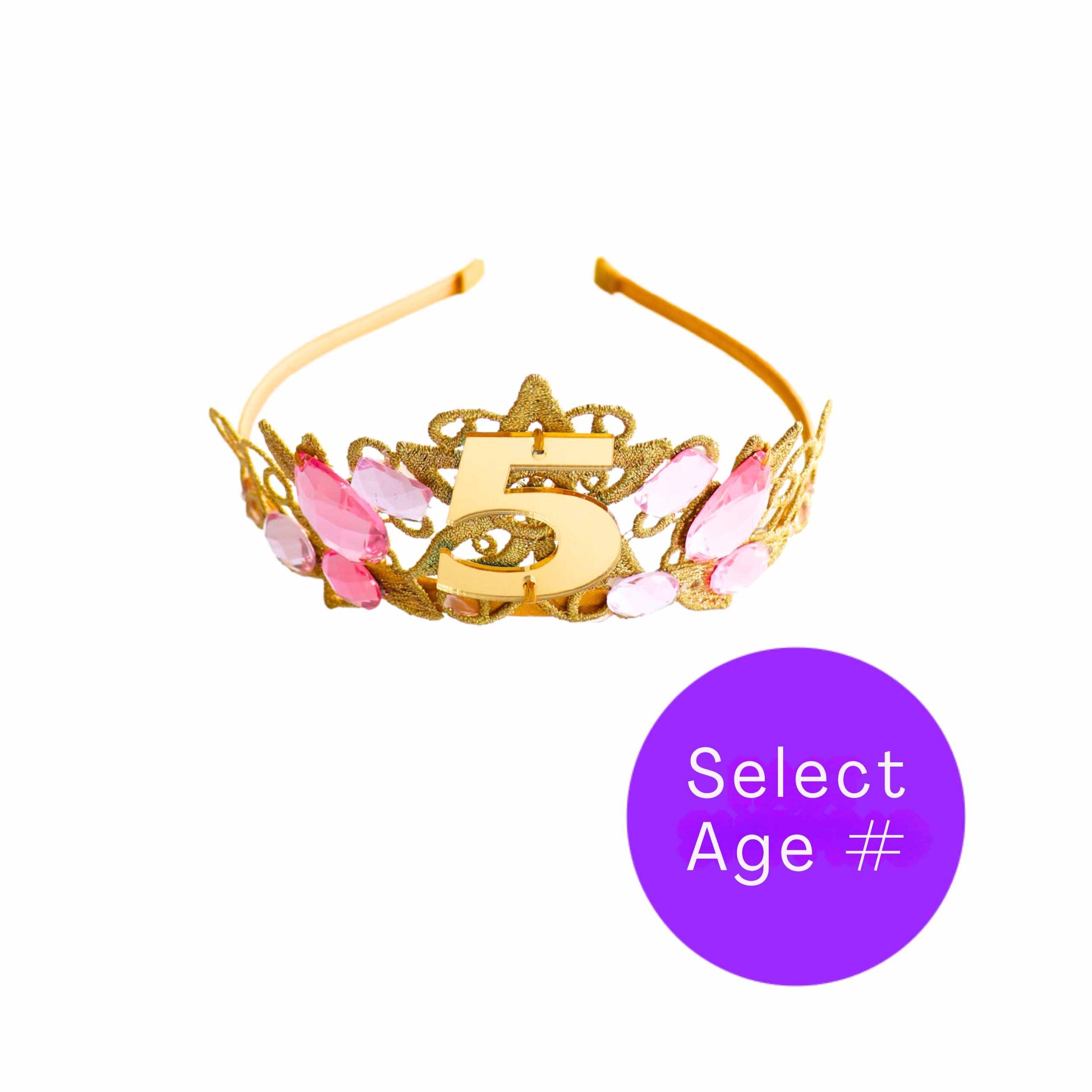 a gold crown with pink flowers and a purple circle