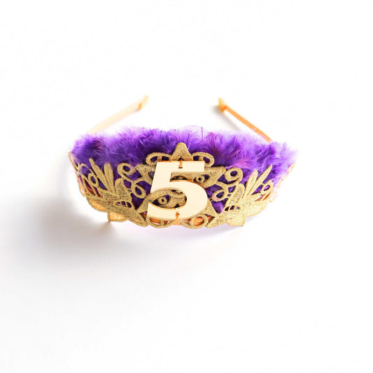 a purple and gold crown with the number five on it
