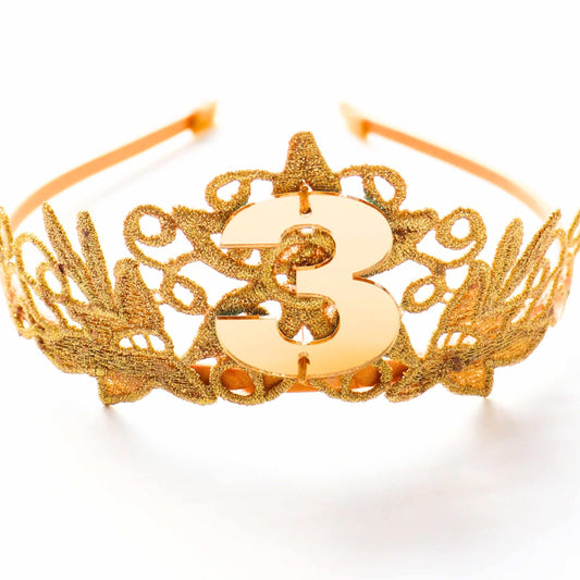 a gold tiara with a number 3 on it