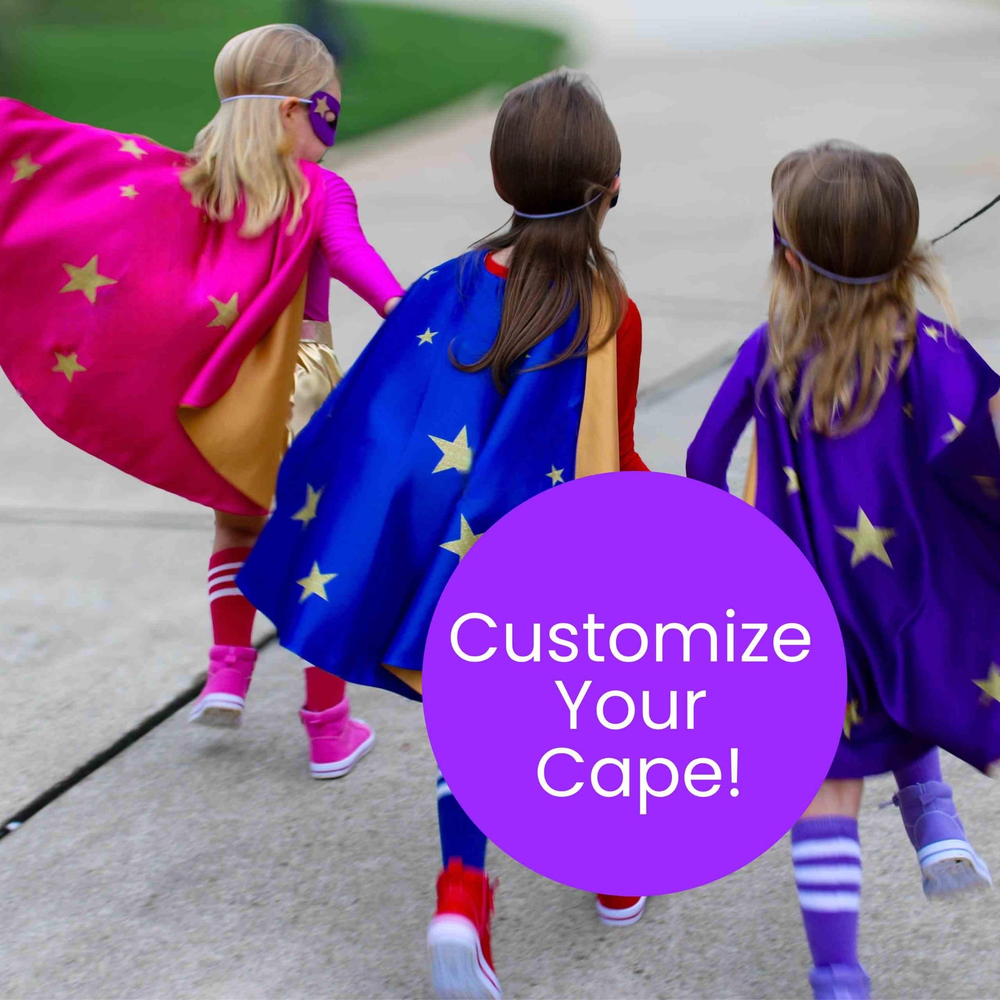 three little girls dressed in costumes walking down a sidewalk
