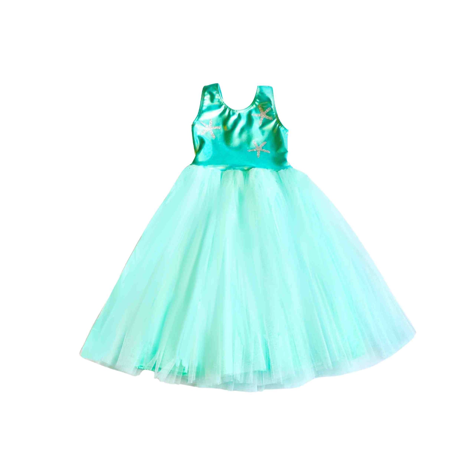 a little girl wearing a green dress on a white background