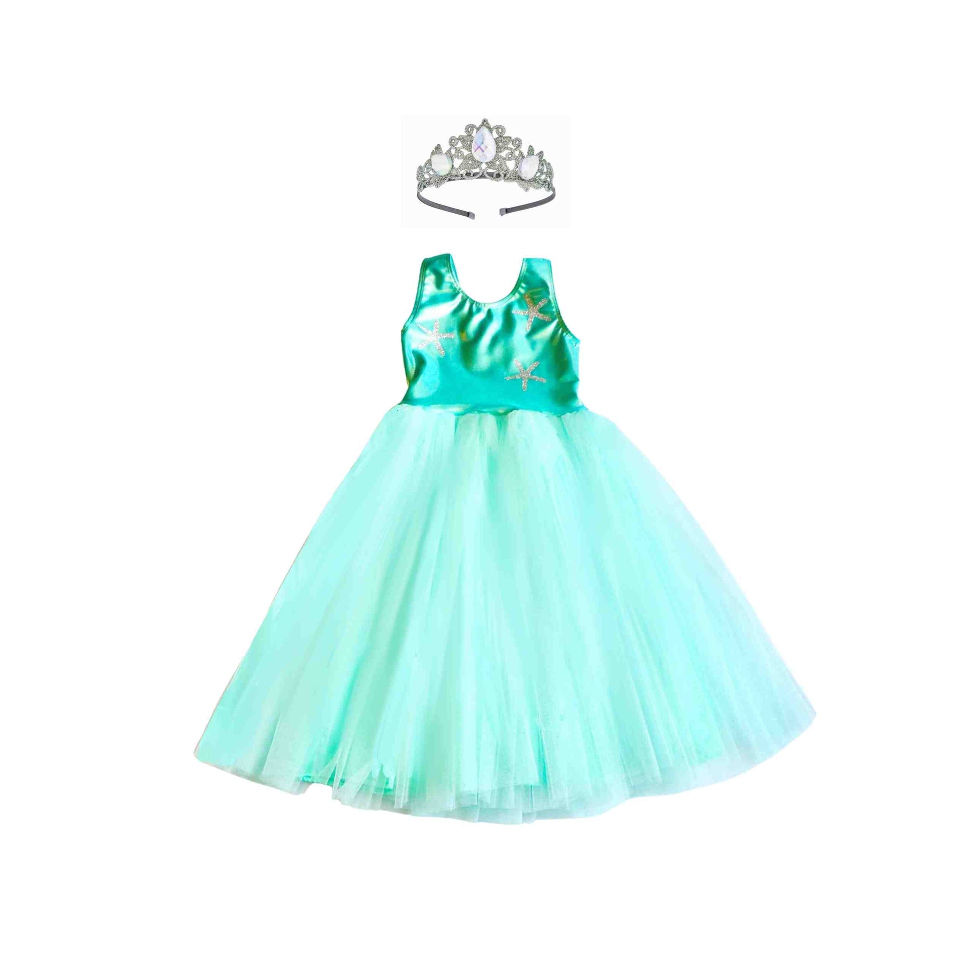 a little girl wearing a green dress and a tiara