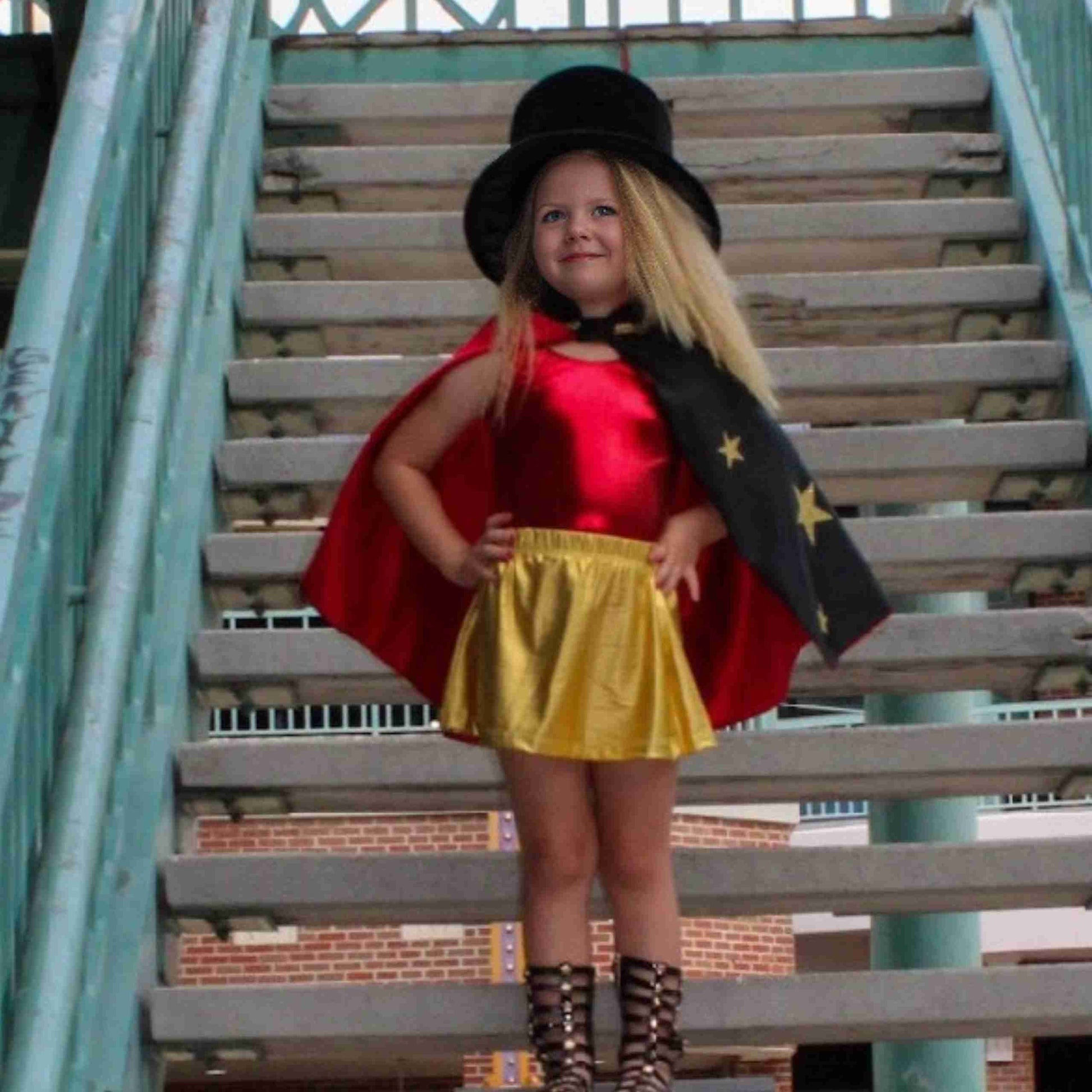 a little girl dressed up as a super hero